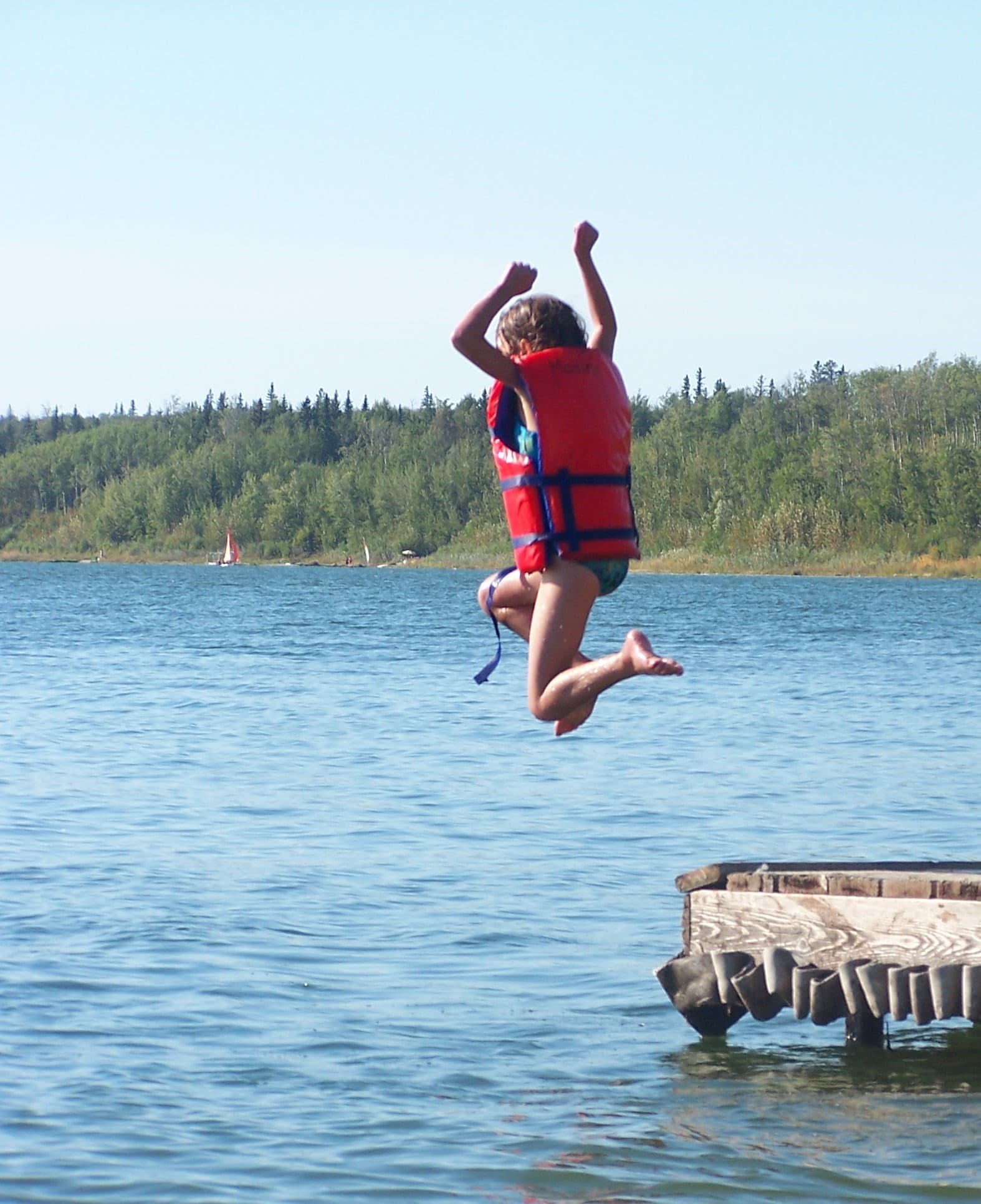 kid jumping into the lake